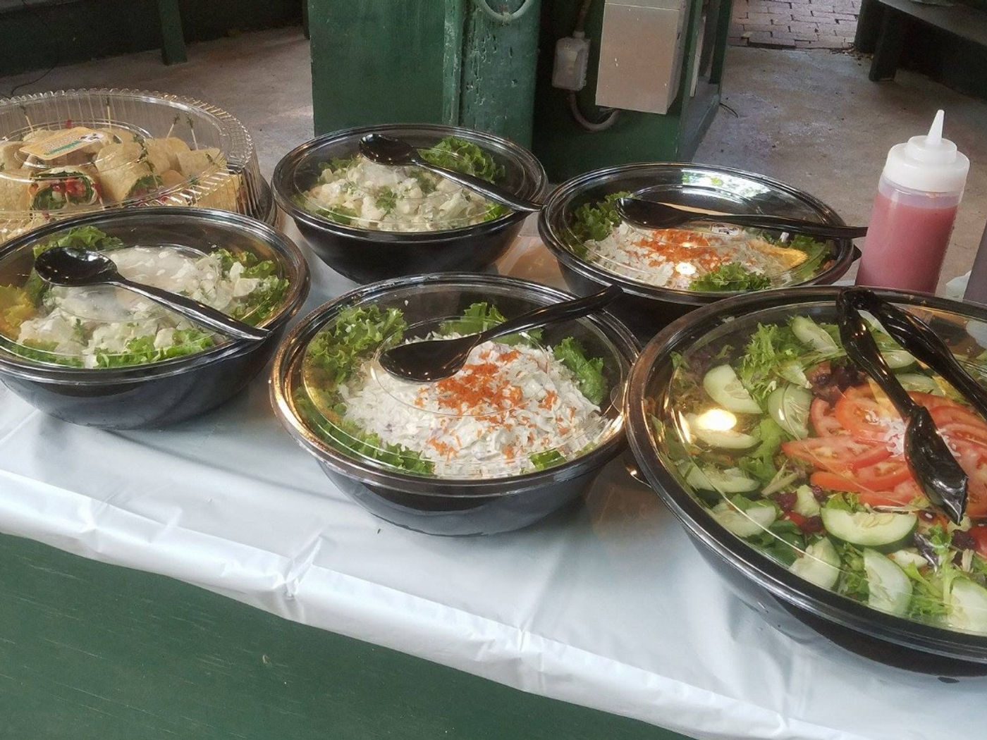 Catering platters of sandwiches, wraps and deli salads