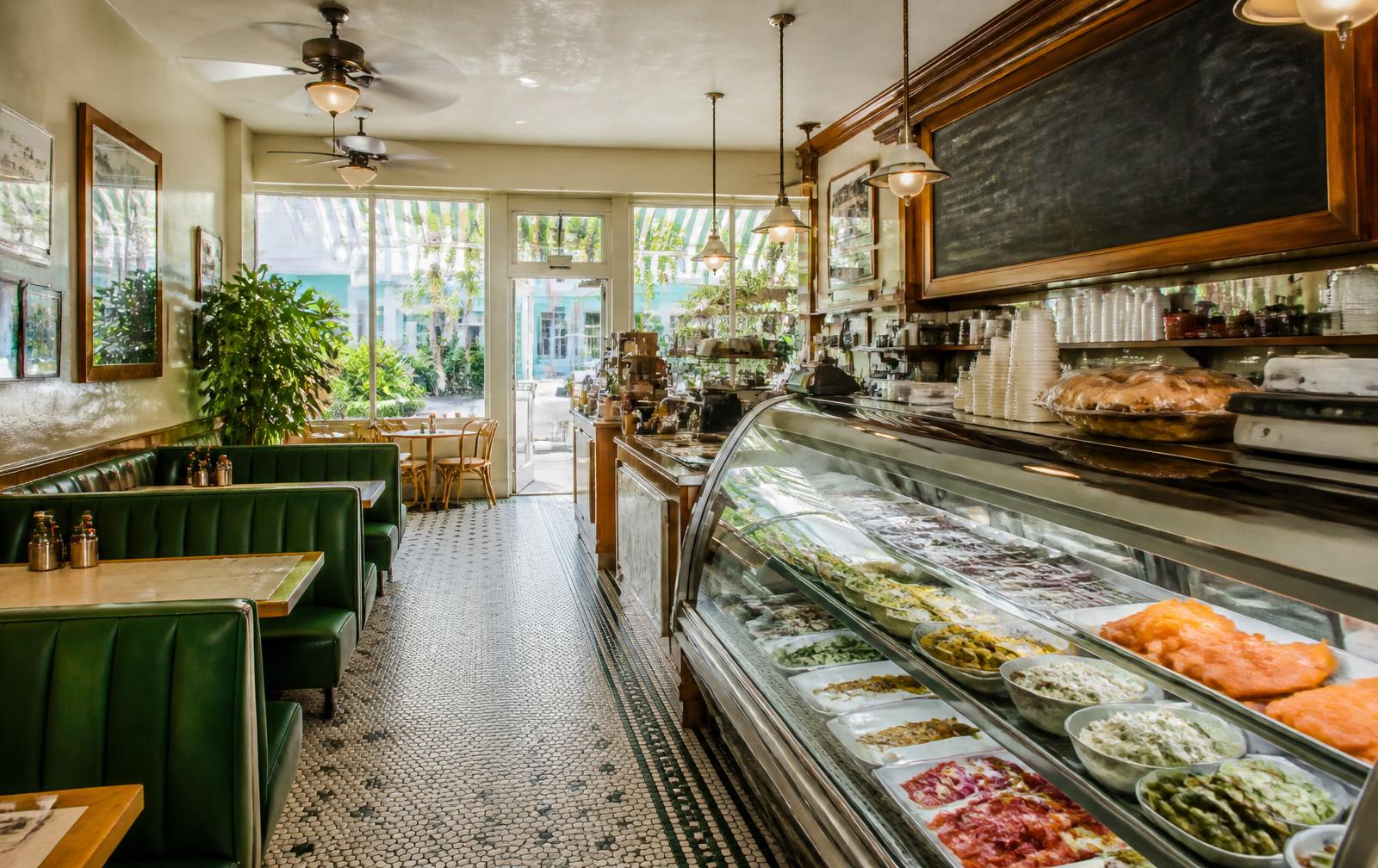 The deli dining room with green booths and a full deli case